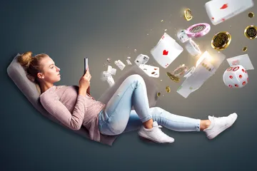 A player using their smartphone during a festive local event, representing MINIMEO fully mobile-friendly casino.